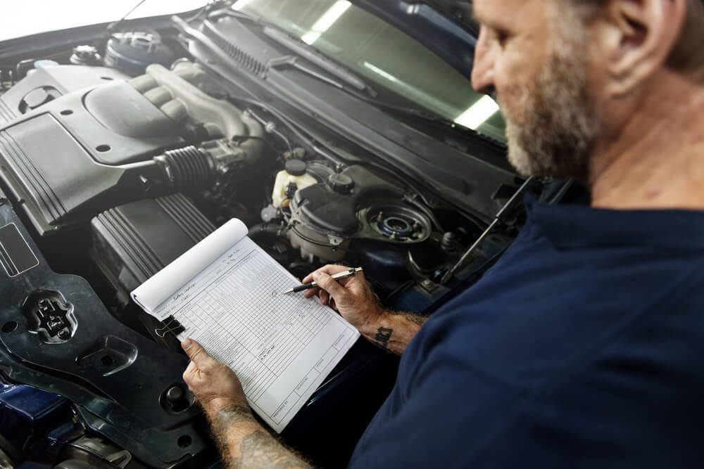 Mechanic conducting out-of-province car inspection