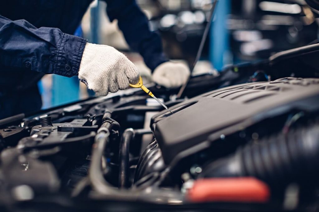 Mechanic working on oil change car