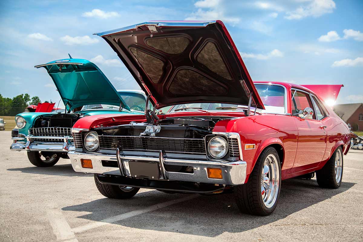 Classic cars in sunny parking lot