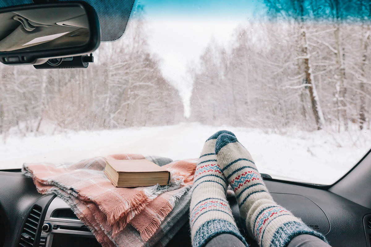 Cozy winter road trip through a snowy forest near Kelowna