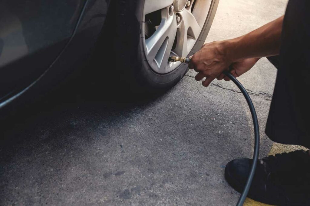 Person applying pressure to his car wheel