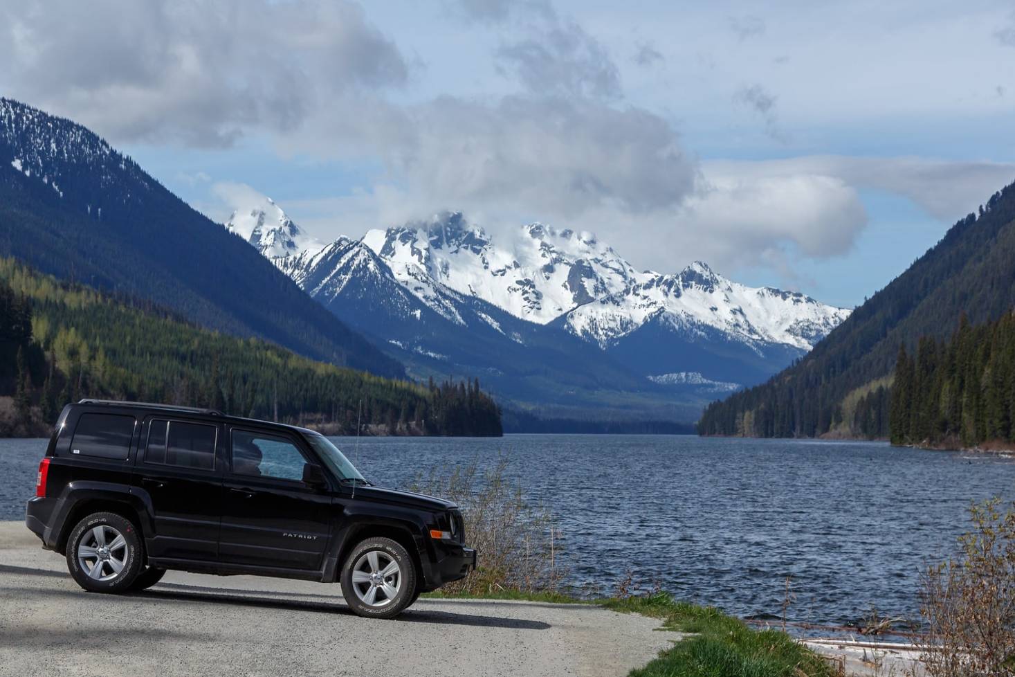 Van with lake and mountains of BC in the backbend