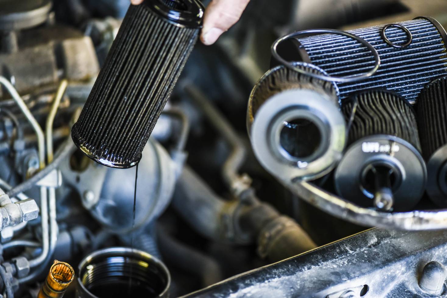 Mechanic changing a dirty oil filter