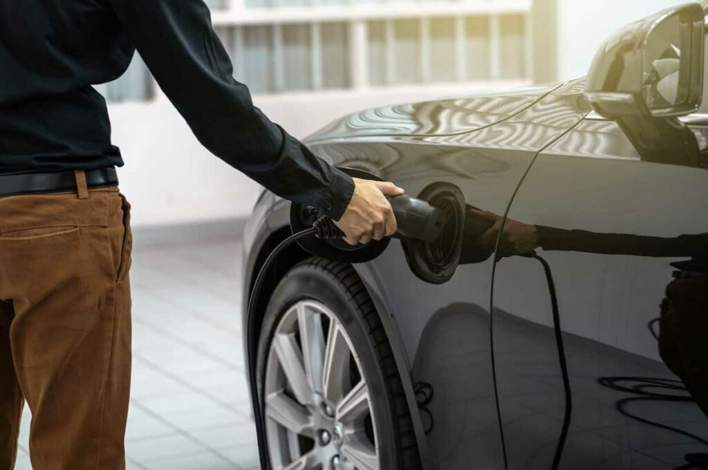 Man charging electric car