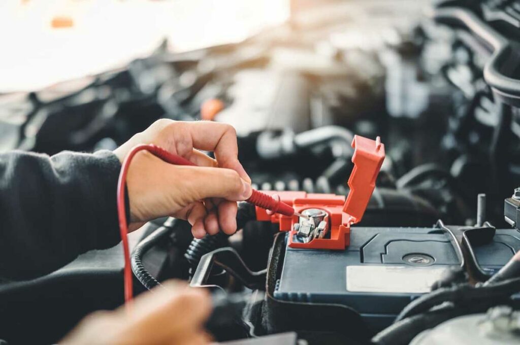 Mechanic testing car battery