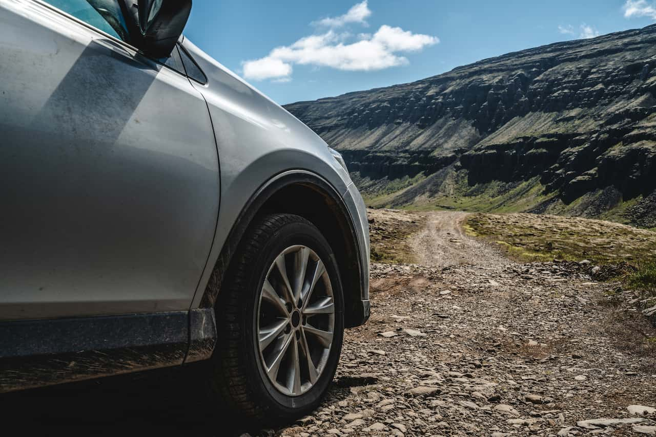 car on a mountainous gravel road