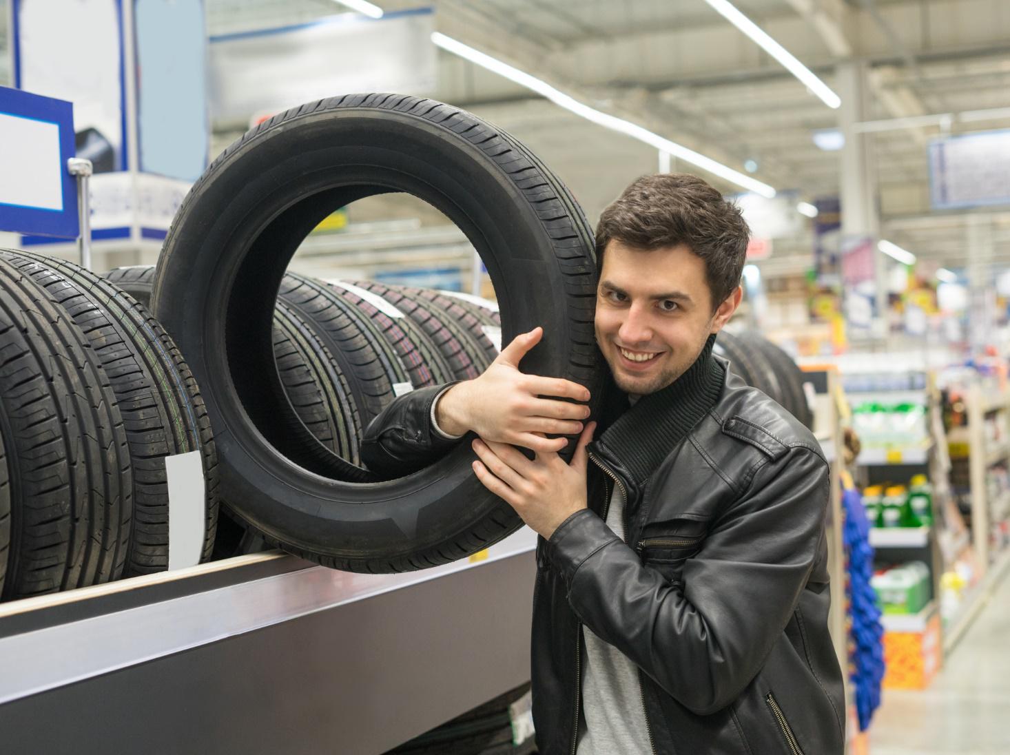 Man buying tire at shop